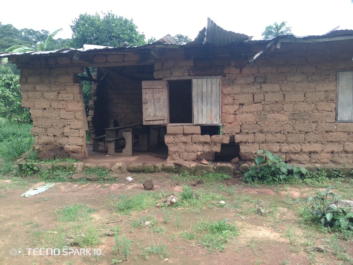 Mud-brick classroom building with wooden shutters